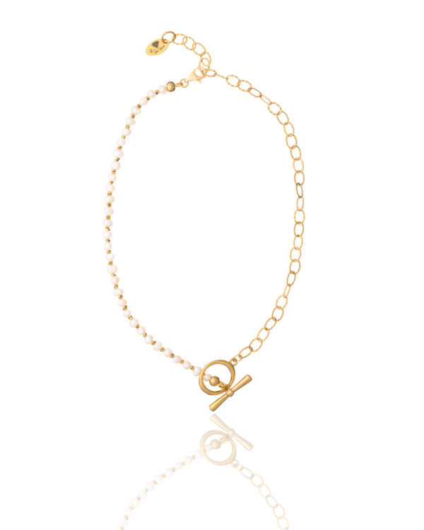 Gold and pearl locket necklace with a delicate chain and toggle clasp